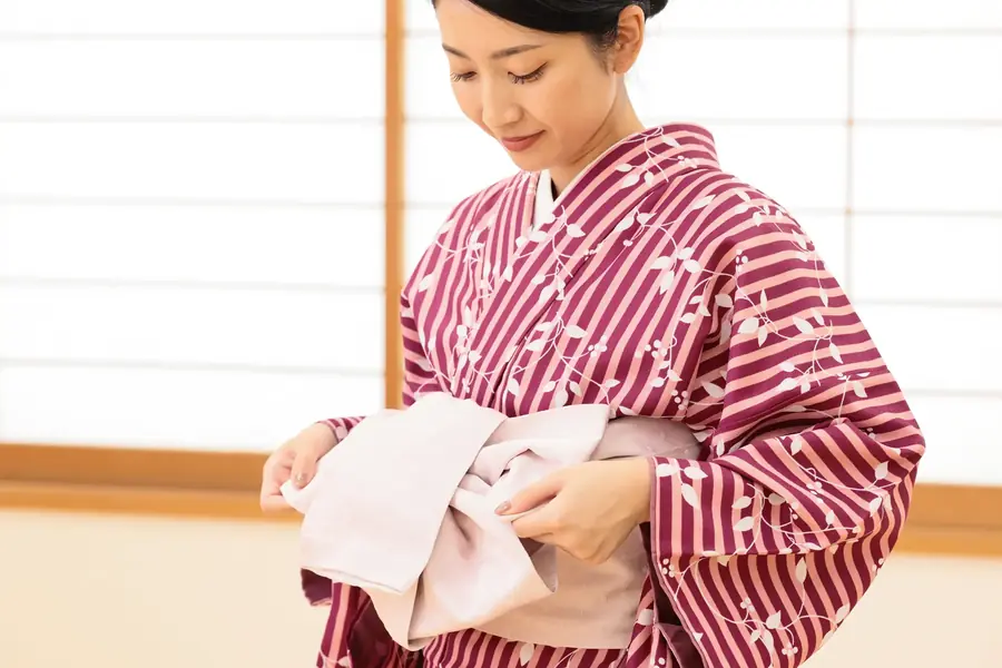 着物姿の女性が帯を整える手元